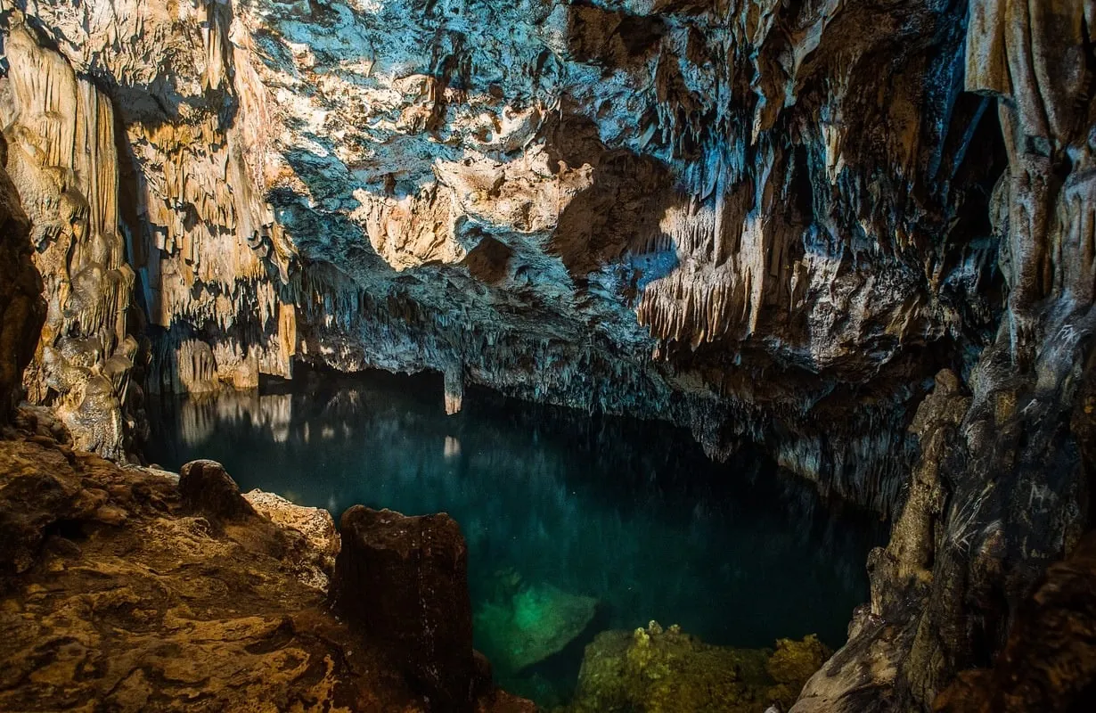 The limestone formations and clear water inside 'Anahulu Cave